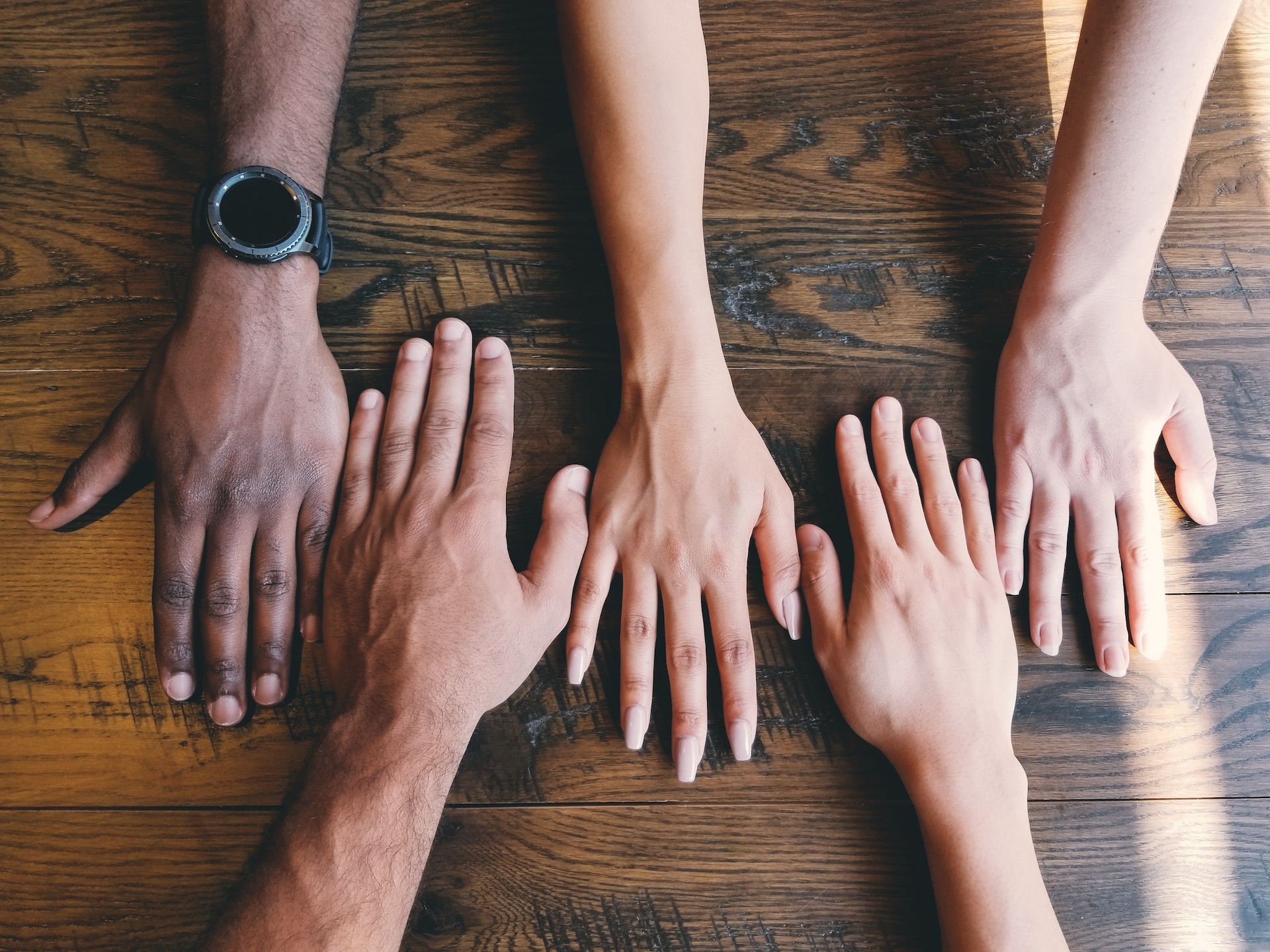 Multiple hands on table