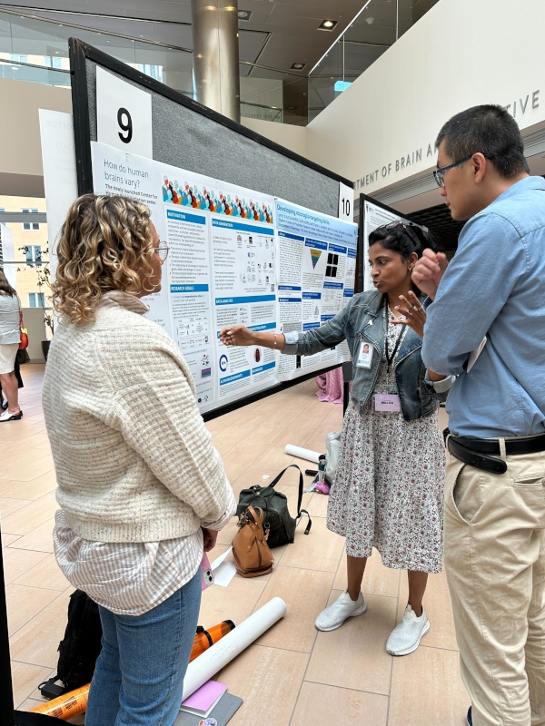Nirmala Rayan presents a scientific poster to a group